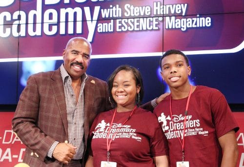 Disney Dreamers Brandon Iverson (right), of Atlanta, Ga., and Armani Young (middle), of Chicago, Ill., pose March 6, 2015 with radio and television personality Steve Harvey (left) during a live radio broadcast of The Steve Harvey Morning Show at Disney's BoardWalk in Lake Buena Vista, Fla. The high school students are visiting Walt Disney World Resort March 5-8, 2015 for Disney Dreamers Academy with Steve Harvey and Essence Magazine. The eighth annual event is a career-inspiration program for 100 high school students from across the U.S. and includes interactive workshops, motivational seminars, hands-on creative experiences and fun times in the theme parks. (Gregg Newton, photographer)