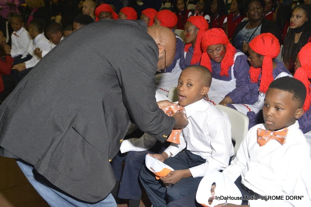Dr. Alvin S. Perry, CEO of PV designs, Inc., helping a Boys 2 Bow Ties step team member tie his bow tie (photo credit: Jerome Dorn of In Da House Media)