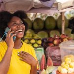 African woman holding a cellphone