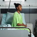 Patient in a hospital bed, Source: Freepik