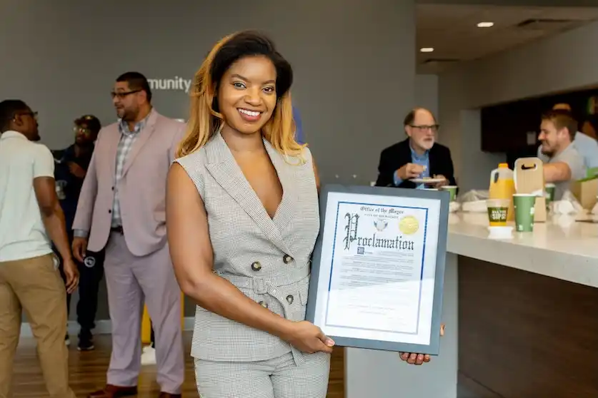 Nadiyah Johnson holding Gov. Tony Evers proclamation of Wisconsin Tech Month. Photograph provided by Wisconsin Tech Month. Photographed by: Justin Smith.